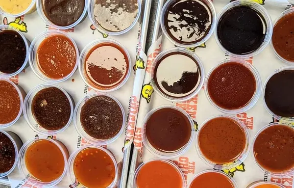 A tray of Chicken Shack sauce cups