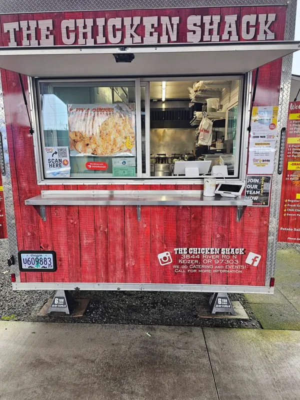 The red Chicken Shack truck with its order window open